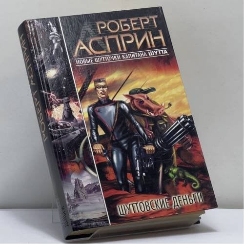 Обложка книги «Шуттовские деньги» — Роберт Асприн, ISBN 9785170092659