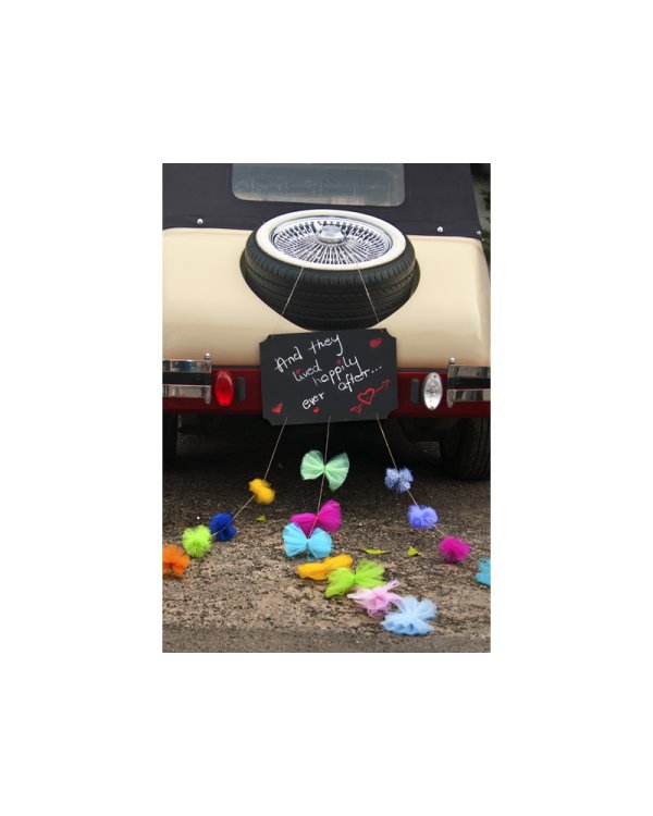 Black chalkboard with pompoms and ribbons